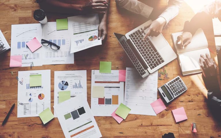 data reports and papers and laptops on desk